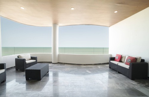 Ixil Apartment | Oceanfront retreat with private balcony, outdoor pool, and stunning views