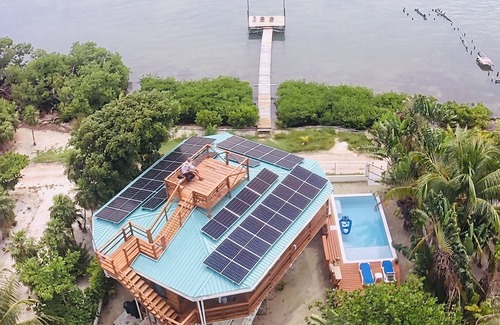 Caye Caulker Apartment | OCEANSIDE 1ST FLOOR APT, OFF-GRID WITH INFINITY EDGE POOL, DOCK, A/C & SMART TV