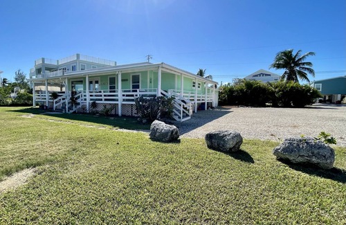 Little Torch Key House | Old Florida Style, wrap around porch, boat basin for dockage, open water