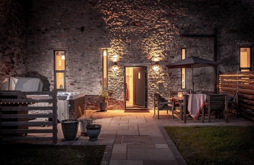 Paignton House | One of 3 cottages, this beautiful barn conversion with a hot tub and EV charger is the perfect place
