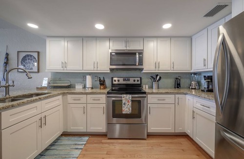 Indian Rocks Beach Condo | One step and you are on the BEACH! Watch AMAZING sunsets from 3 decks!
