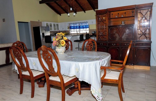 Red Gate House | Open-concept living space cascaded in palm and fruit trees.nFamily-friendly!
