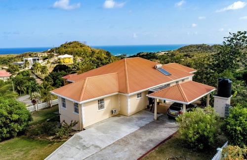 Red Gate House | Open-concept living space cascaded in palm and fruit trees.nFamily-friendly!
