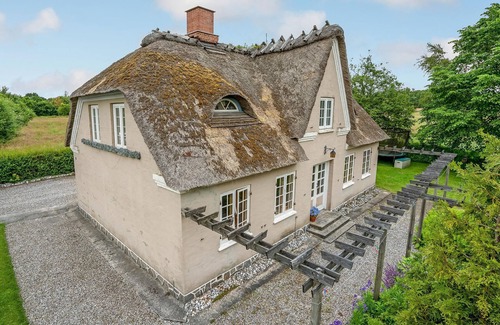 Krusaa House | Outside Krusau welcomes you this beautiful thatched house.