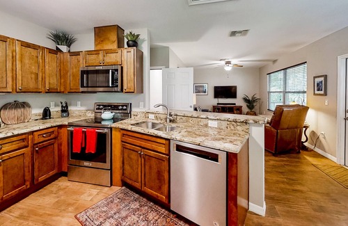 Weeki Wachee Gardens House | Palm-lined home with water access, game room, balcony, W/D, and central AC