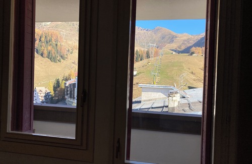 Foppolo Apartment | Panorama of Foppolo, the mountains and the slopes in the morning sun
