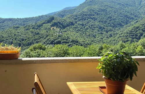 Sanfront House | Panoramic two-story dwelling with private garden, surrounded by green woods.