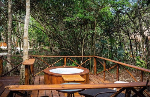 Akumal Cabin | Peaceful Getaway in the Jungle with AC and private deck with Hot Tub.