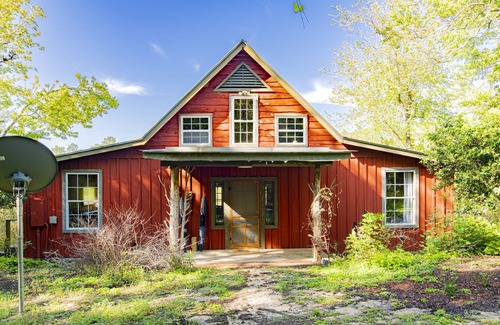 Fairhope Cabin | Private cabin built over a lake with a large breezy screened-in porch.