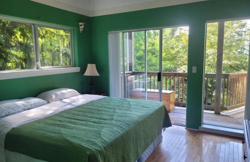 Powell River House | rainforest suite with a king size bed