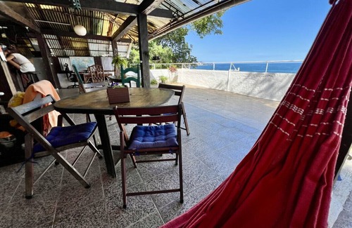 Vidigal Apartment | Relax and watch the sunrise across the ocean from your hammock. Views of Ipanema across the water