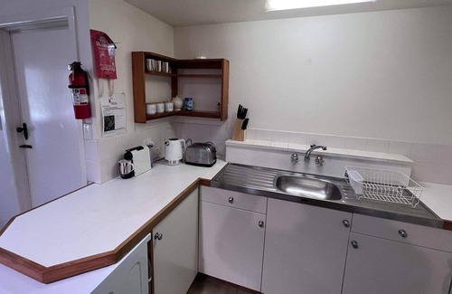 Burnt Pine Cottage | Relax in a 2 bedroom cottage a short walk from cafes, restaurants and shops