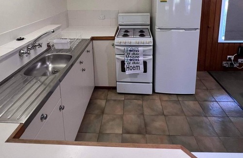 Burnt Pine Cottage | Relax in a 2 bedroom cottage a short walk from cafes, restaurants and shops