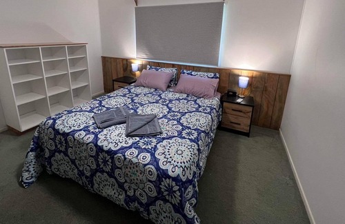 Burnt Pine Cottage | Relax in a 2 bedroom cottage a short walk from cafes, restaurants and shops