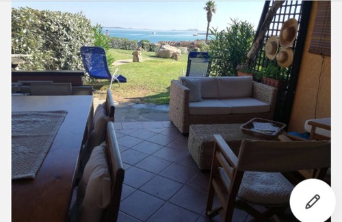 Golfo di Marinella Apartment | Relaxing beachfront apartment with spacious veranda, pool, a/c, parking
