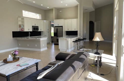 Estero House | Renovated open floor plan with large heated pool and screened lanai with dining.