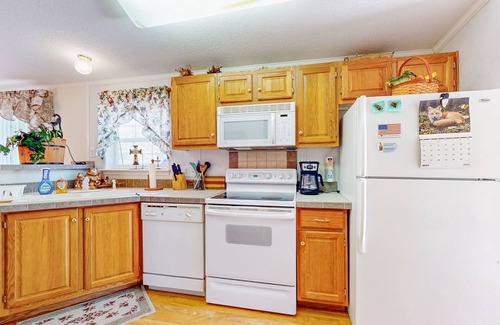 Sparta House | Riverfront home with a large yard, fireplace, deck, & washer/dryer