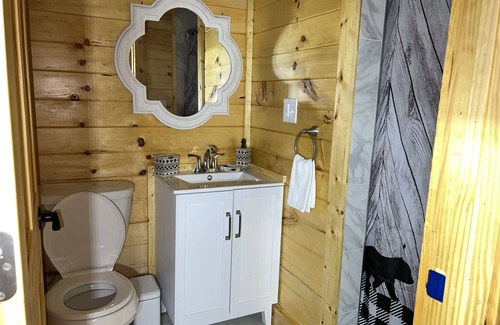 Newland Cabin | Riverfront Luxury Log Cabin with outside fire pit and deck overlooking the water