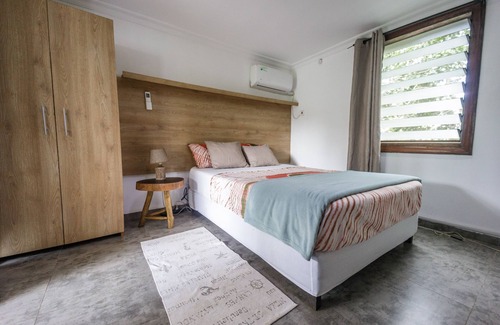 Aburi Bed & Breakfast | Rustic and unique private room with large wraparound balcony up in the Trees!