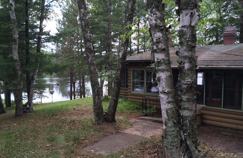 Bigfork Cabin | Rustic cabin in remote wooded area on point overlooking lake.