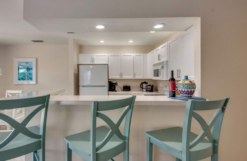 South Island House | Sand Dollar #3 - Upstairs Apt with Shared Pool on Canal by the Beach!
