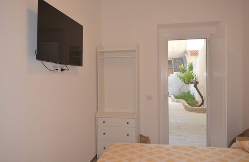 Sant'Antioco House | Sant Antioco Yellow Apartment with 2 Way Air Con