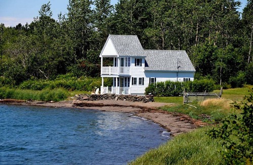 Eastport House | Sea-Breeze Cottage perched on the edge of the bay.