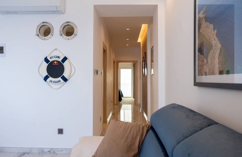 Bugibba Apartment | Seafront Bugibba apartment with balcony and stunning 180° views. Bright, beach-style interiors, lift access, and steps from dining and the shoreline.