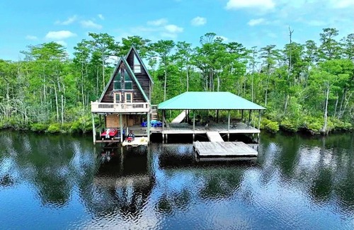 Satsuma Cabin | Secluded cabin on the water with jetski, hottub & kayak! Pets OK & early checkin
