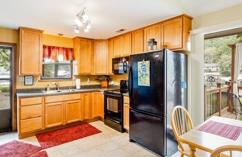 Sunrise Beach Cabin | Secluded lakefront home with private dock, firepit, grill, water views, hammock