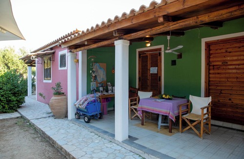 Vasilikos Cottage | Self catered cottage with large veranda and garden with hammock near the beach.