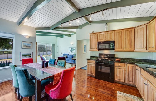 Gualala House | Serene guest suite with shared hot tub, forest views, & splashes of color