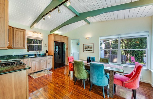 Gualala House | Serene guest suite with shared hot tub, forest views, & splashes of color