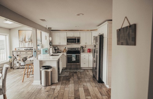 Portage Lakes Cottage | SLICE OF HEAVEN lake front cottage with HOTTUB, fire pit, kayaks & Dog friendly!