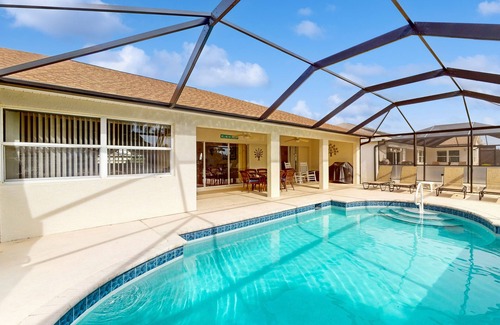 Biggar Villa | Spacious Lakefront Home with a Screened-In Pool in Exclusive Community
