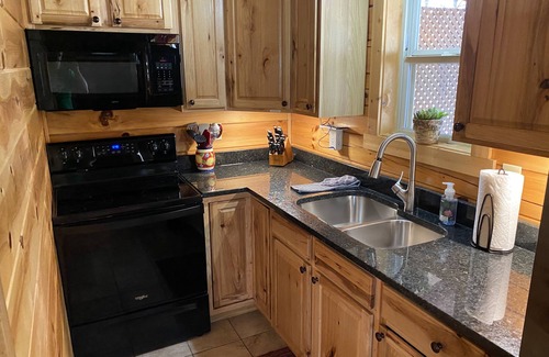 New Plymouth Cabin | Spacious Log Cabin with Hot Tub, Fire Pit, Large Decks & Wood Fireplace
