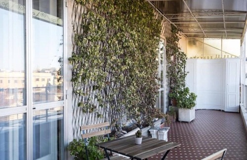 Esquilino Apartment | Spacious penthouse with gym in historic building, near the Colosseum