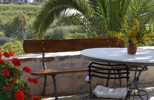 Syros Cottage | Stone-built studio under two Eucalyptus trees.