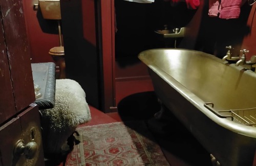 Akaroa House | Stylish vintage caravan on a farm over looking bush and river.