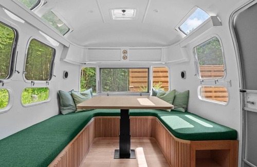 Delancey House | Sunlit Airstream in Trees with Expansive Deck + Nature Views