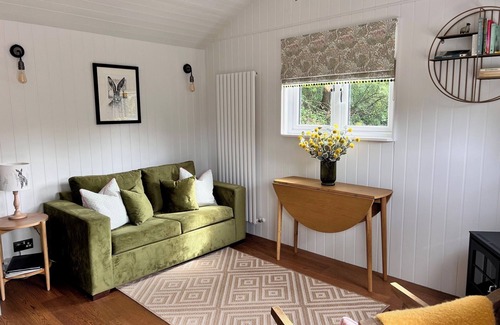 Pulborough Cabin | Sunset - nestled in a wildflower meadow on a farm with Highland Cows