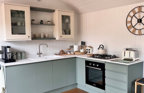 Pulborough Cabin | Sunset - nestled in a wildflower meadow on a farm with Highland Cows
