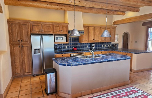 Arroyo Seco House | Sweeping panoramic mountain views, expansive adobe privacy wall system
