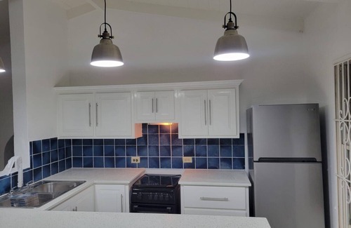 Dickenson Bay Apartment | Swimming Pool- Balcony/Veranda- Sea & Sunset Views