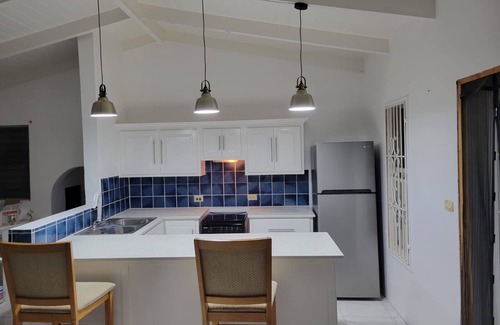 Dickenson Bay Apartment | Swimming Pool- Balcony/Veranda- Sea & Sunset Views