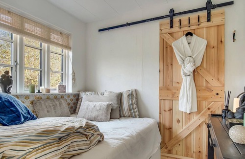Dalby Huse House | Take your dog on vacation with you in this inviting cottage with outdoor hot tub.