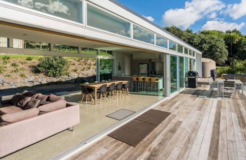 Mangawhai House | The Glass House - Modern, pet-friendly designer holiday home with spectacular views and spa pool