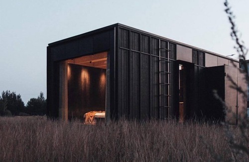 Wilsum Cabin | The Nokken Forest Cabin stands on the edge of the forest with unobstructed views over a rolling landscape. This cabin offers a lot of privacy due to its location. The large window is facing west. Enjoy the sunset over an endless cornfield from your b