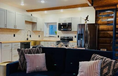 College Cabin | This beautiful log cottage has large windows that let in lots of light