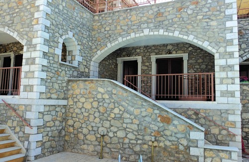 Paralia House | This stone vacation property on two levels is one of three terraced houses sharing a swimming pool.